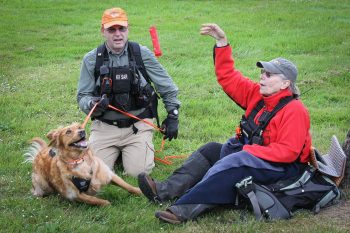Ruger about to receive his reward toy from Dana Lerma, whom he'd tracked for about a mile through Port Gamble, WA. (Photo by JB Goessman)